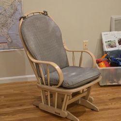 Slider rocking chair with grey cushions