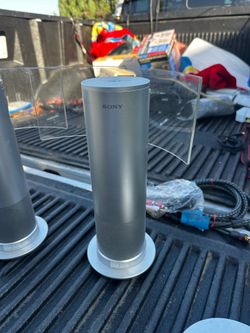 Sony SRS-RF90R wireless speaker featuring a distinct cylindrical design with a transparent reflector panel.