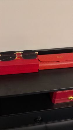 Black frames gold arm Cartier glasses