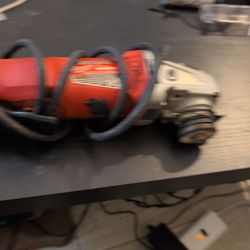 Based on the image, the item is a Milwaukee electric angle grinder, typically used for metalworking, cutting, and grinding. 
Brand: Milwaukee Tool. 
K