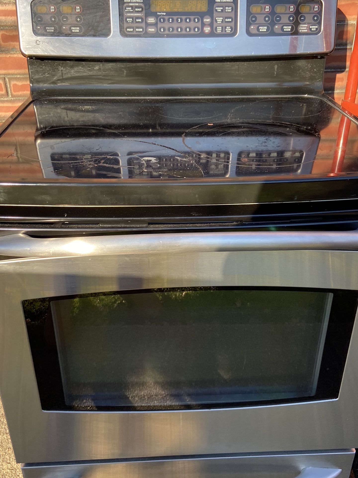 GE electric convection range. Roughly 10 years old. Still works great. Front left burner glass top is cracked. Burner still works