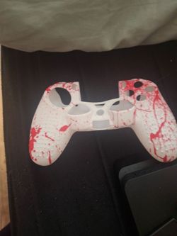PS4 console w/ silicon biohazard controller skin and a charging station