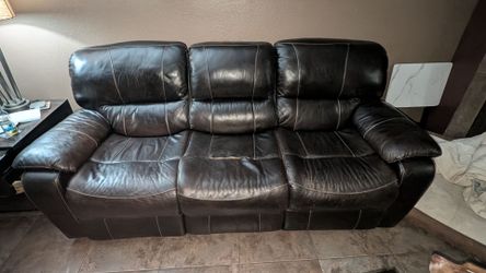 Dark brown leather reclining couch and love seat