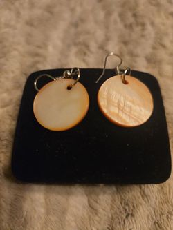 hand-carved Mother of Pearl Koru pendant & The selected items are Mother of Pearl round disc earrings. These simple, lightweight dangle earrings are c
