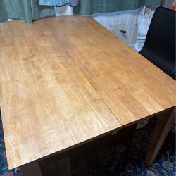 Solid wood table with attached leaves