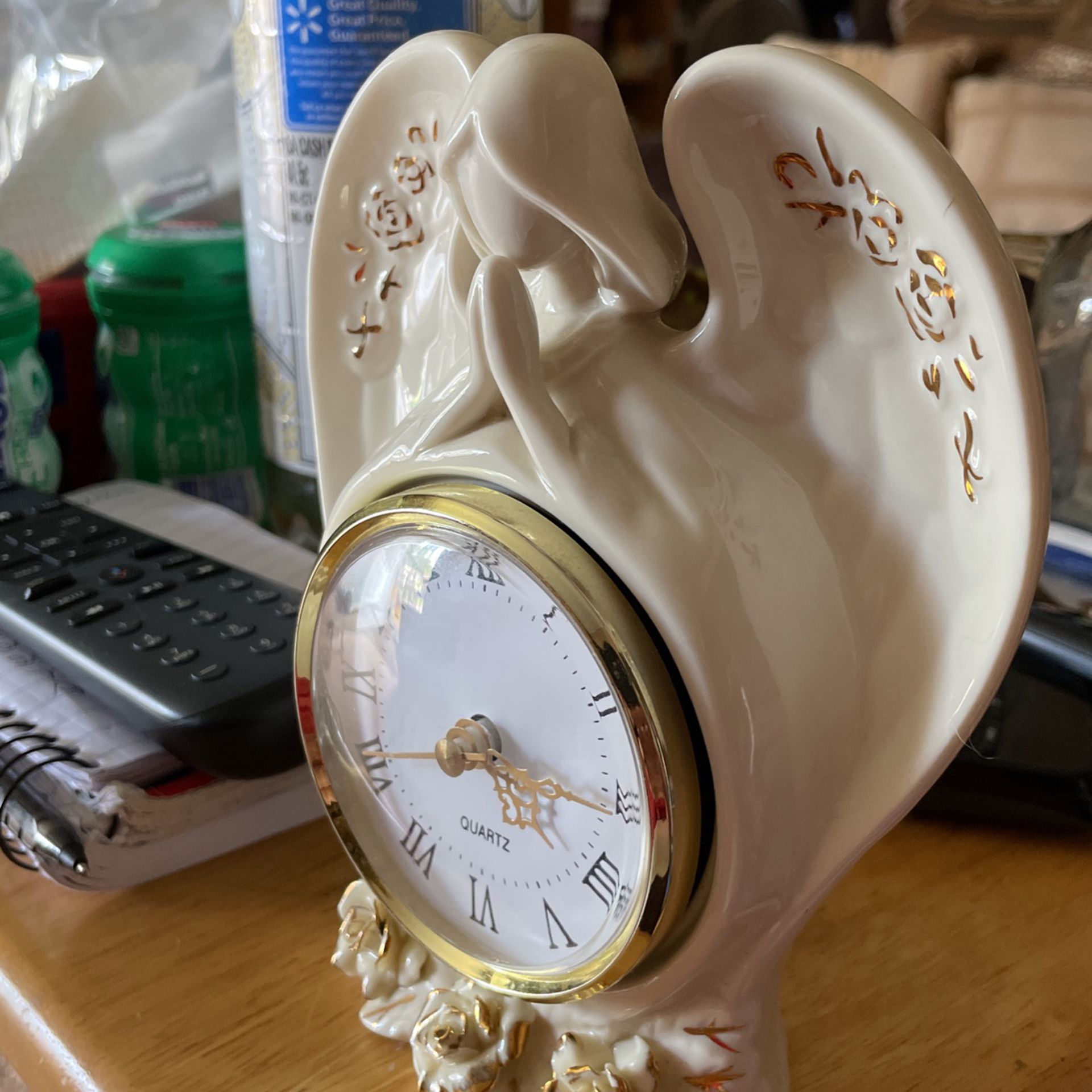 Beautiful angel clock with flowers on the bottom around the wings.    Or Best Offer