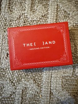 {THE AND} Amusing Edition relationship card game by The Skin Deep, featured in a bright red box.