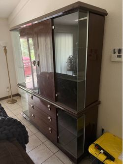 Glass display case with drawers.