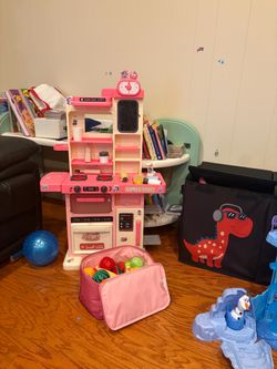 Pink Toy Kitchen with a bag of fruits and Disney Frozen Ice Castle Playset