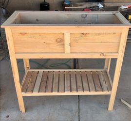 Raised planter boxes with shelves