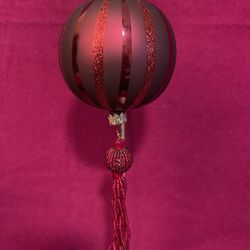 Vintage glass Christmas ornament with glitter stripes and a beaded tassel