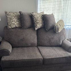 2 to 3 person couch and pillows.