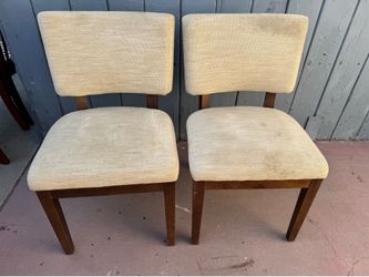 Two regular Vintage upholstered chairs. The chairs have wooden frames and light beige fabric upholstery. Fabric is textured. Dimensions from the botto