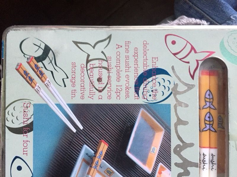 New 12 piece sushi plates and chopsticks in a decorative metal tin factory sealed