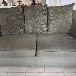 Green Sofa with Patterned Cushions
