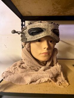 Star ways Rey mannequin head with wrap and glasses.