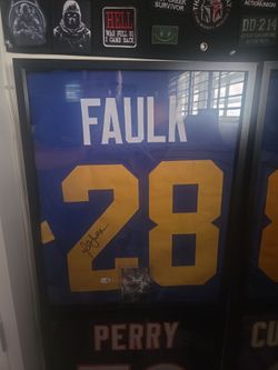 La Rams Faulk signed jersey framed.