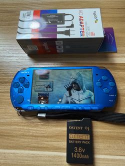 Blue PSP 3000 with 100 games installed.             U99