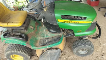 $200 for a John Deere riding lawn mower it won't take much to get it running it's not locked up it turns over by hand or make me an offer everything g