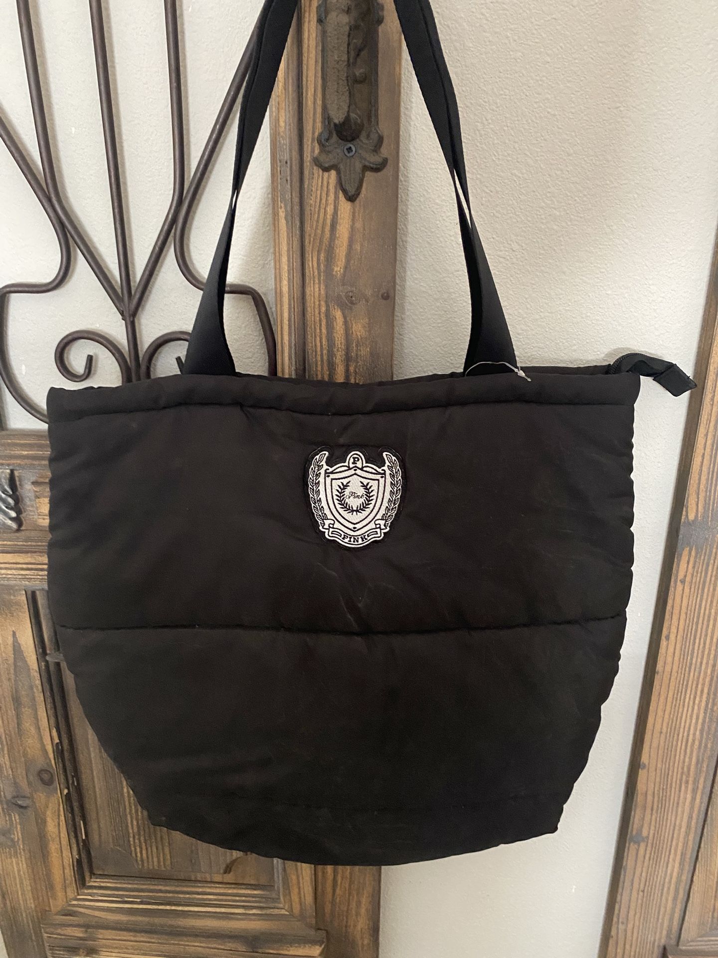 This is a black quilted puffer tote bag by Victoria's Secret PINK