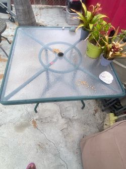 Outdoor glass table with umbrella, hole and chair