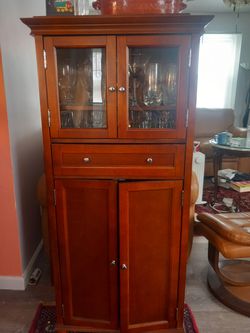 Wooden cabinet with glass display and storage