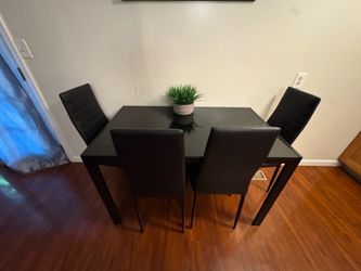 Black dining table with glass top