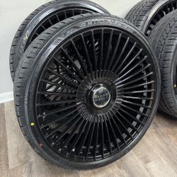 New 24 inch gloss black wheels with floating Range Rover caps wrapped in Lexani 295/30r24 tires