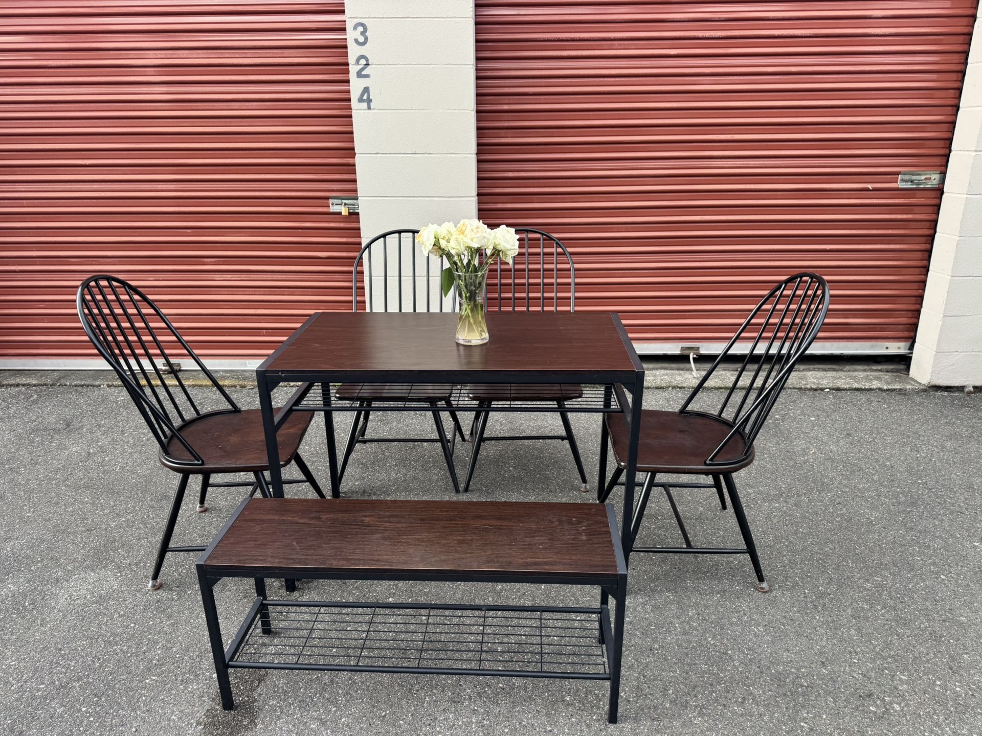 Wooden table and four chairs and a bench