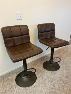 2 brown leather stool bars
