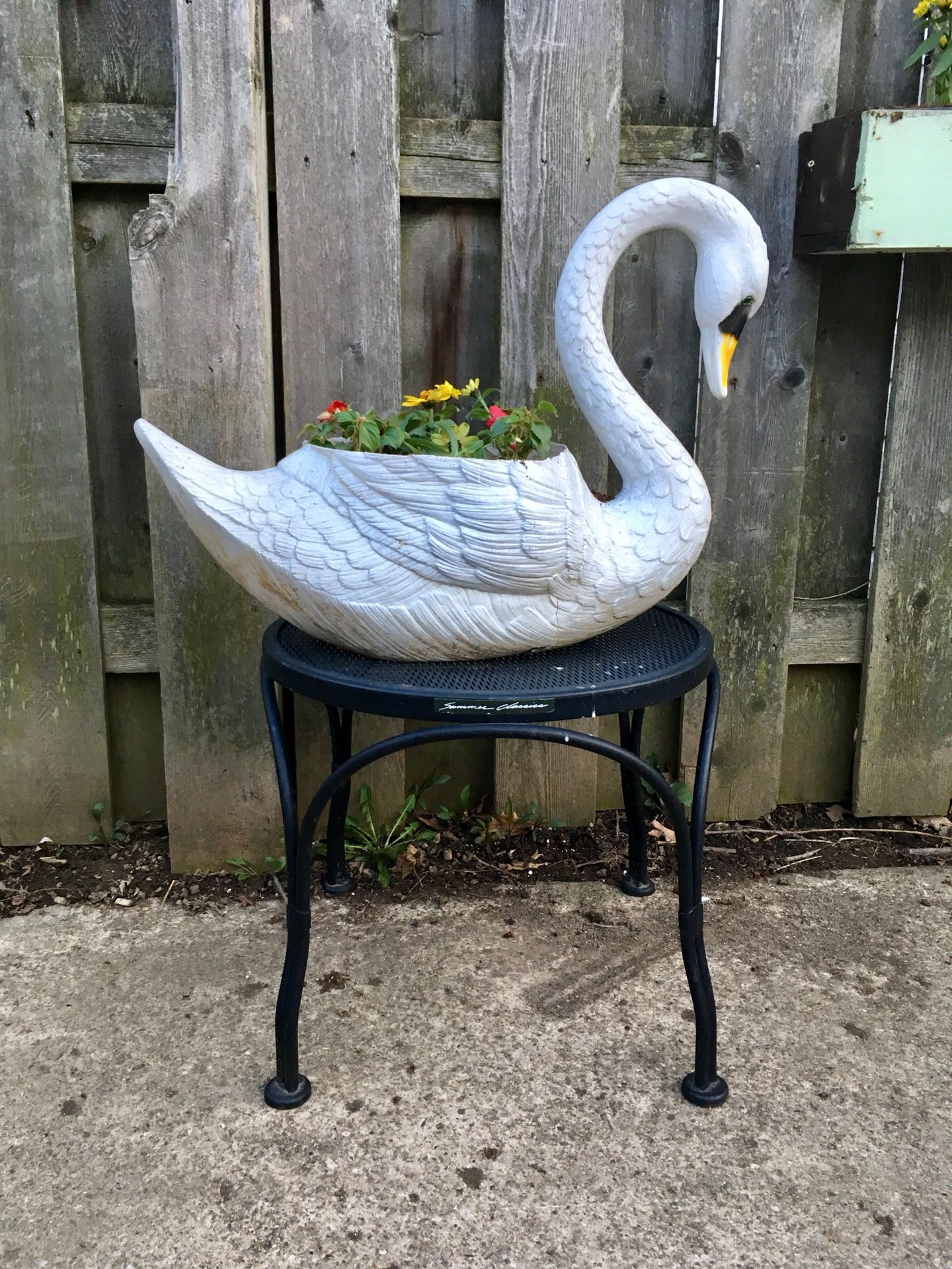Swan planter (plastic) with plants $10. Black metal small plant stand/outdoor table $10