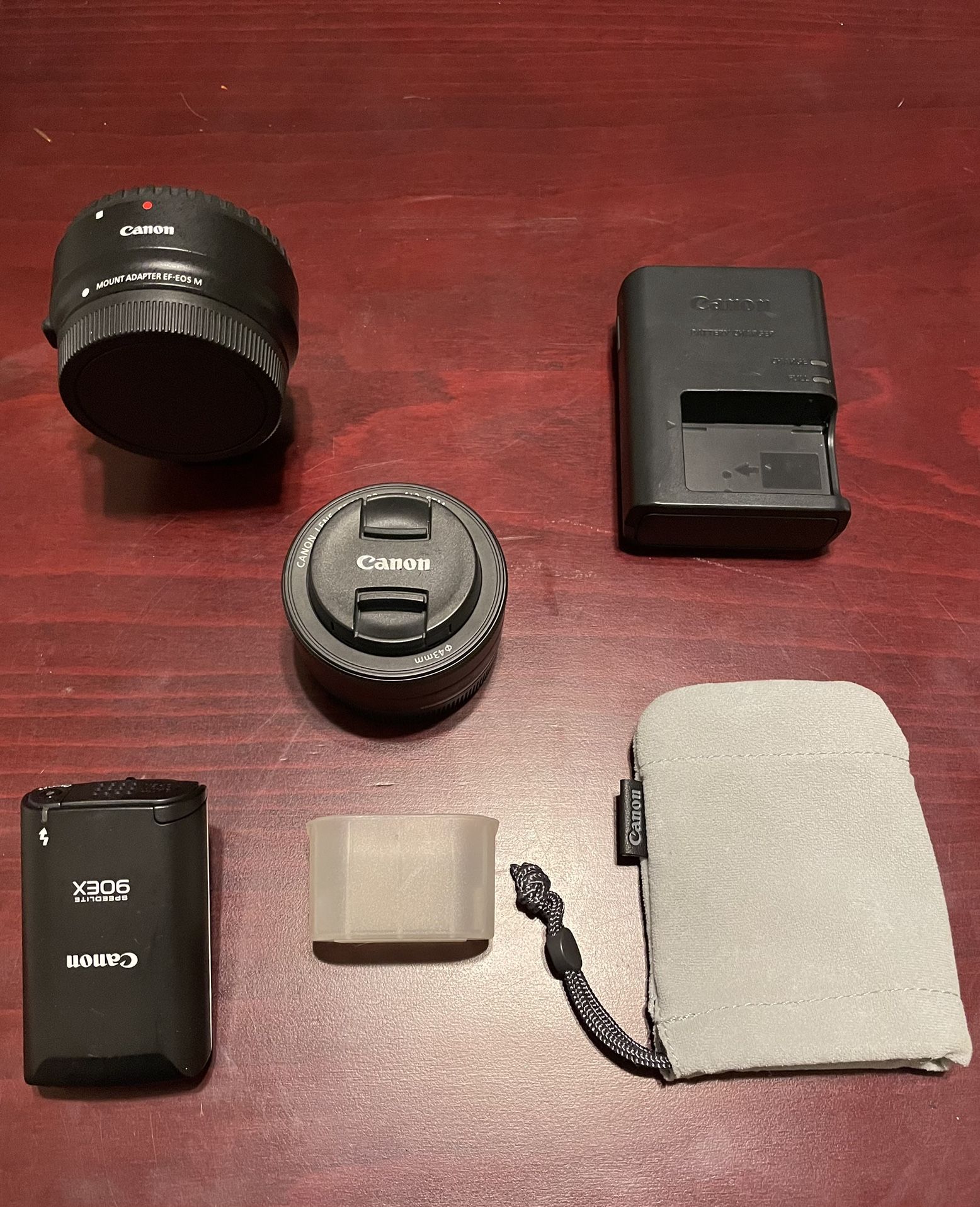 Canon EOS-M Accessories: Flash, Diffuser, Lens, Lens Adapter, And Battery Charger.