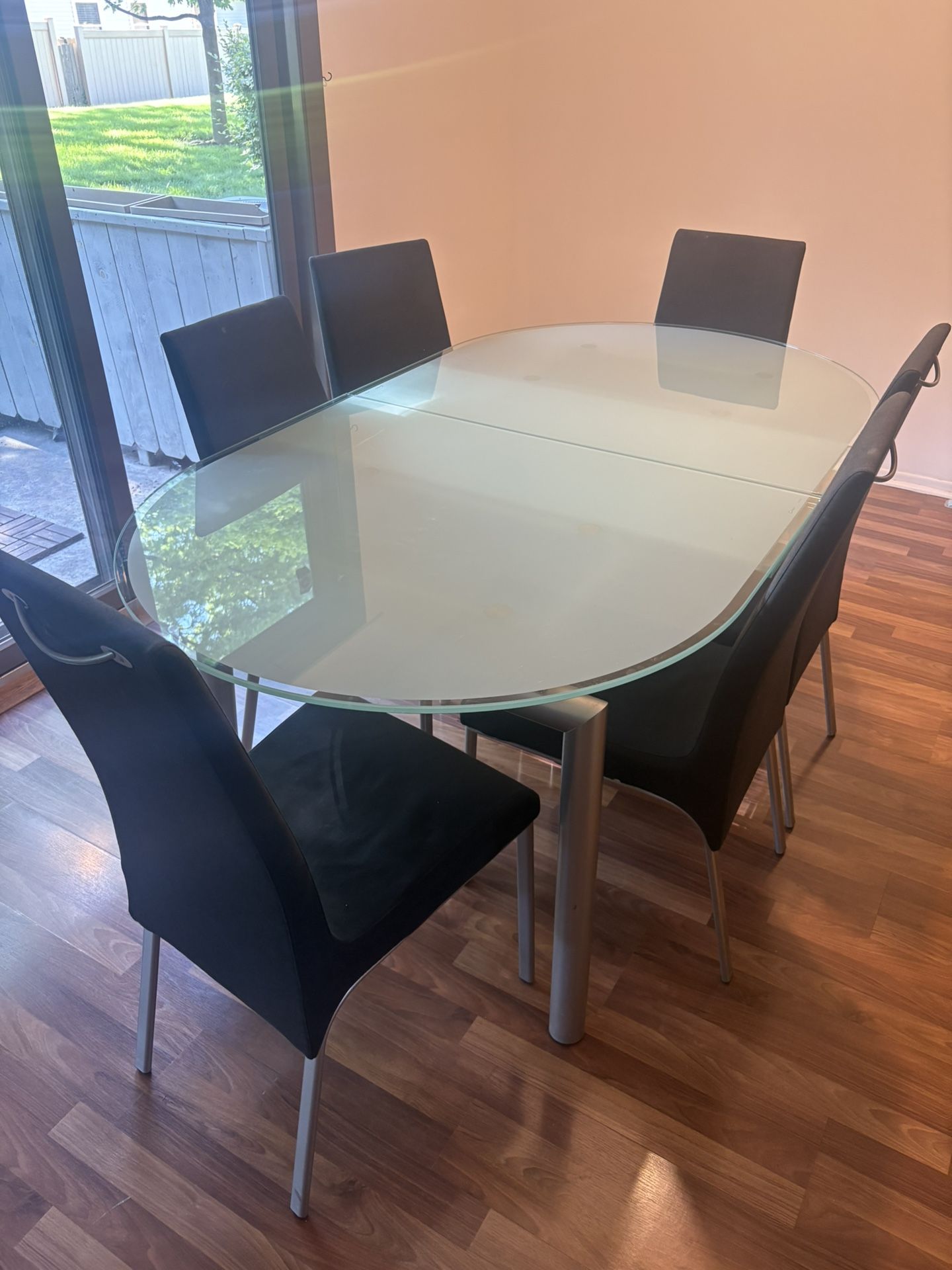 Glass Top Table With Build In Extension And 6 Chairs That Have Removable Covers