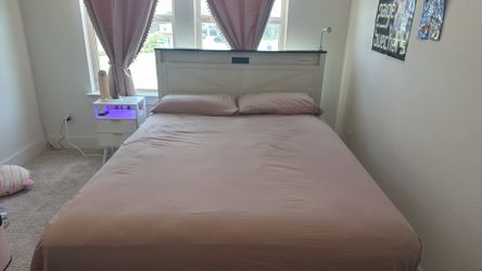 Queen size bed frame with head and foot boards.