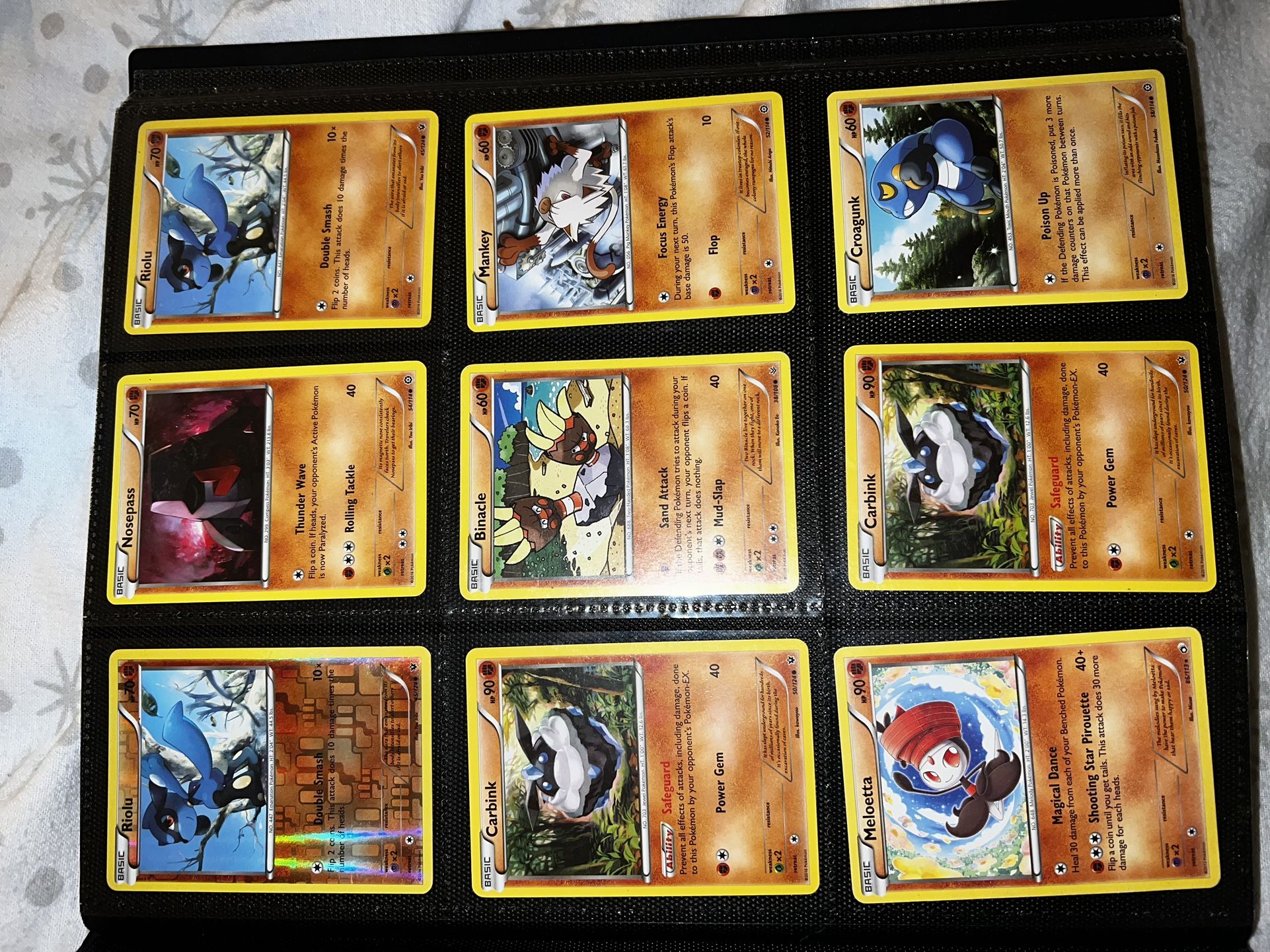  a collection of various basic Pokemon cards from the "XY" set, including Riolu, Nos