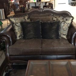 Love Seat. Brown, With Brown Leather and Brown Wood Trim. 5ft. 6in. wide. Excellent Condition .