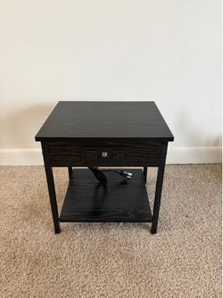 Small black end table with charging station