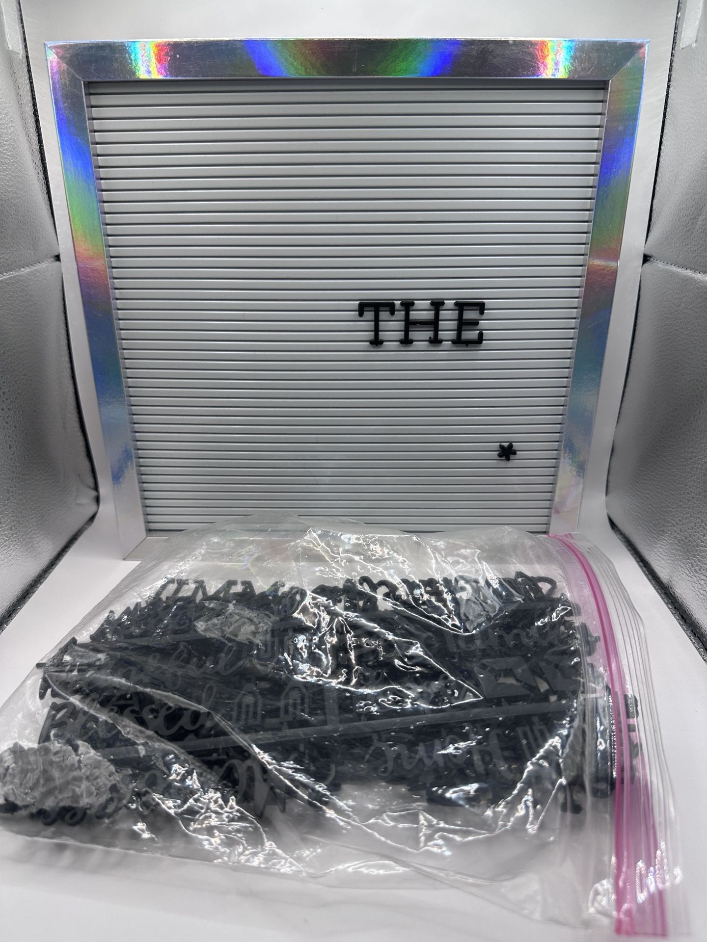 Silver and White Letter Board With Assorted White Letters and Words