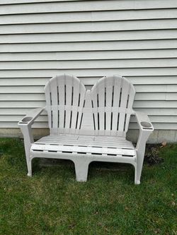 Double seater plastic bench with arm rest and cup holder. Beige.