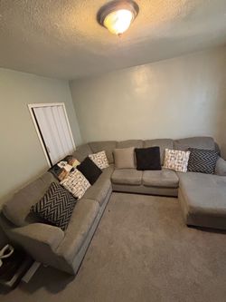 (Sectional) left arm sofa and right arm chaise, like a tanned light grayish color,