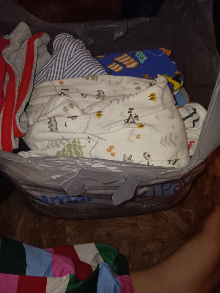 Grocery bag full of baby boy clothes