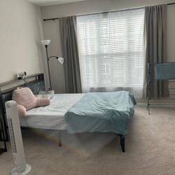 Queen bed frame with mattress and pillows