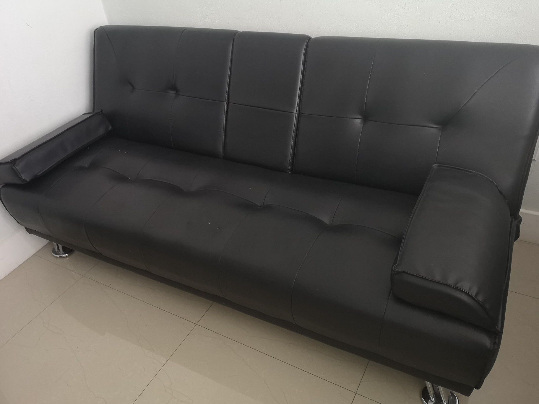 Black bonded leather futon, reversible with cupholder. Good condition!!