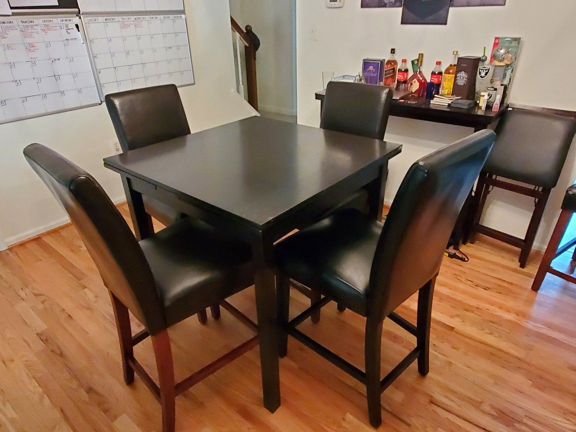 High quality high top table that seats 4 or 6. Includes 6 chairs that i bought separate. 1 chair is different color as you can see in pictures.