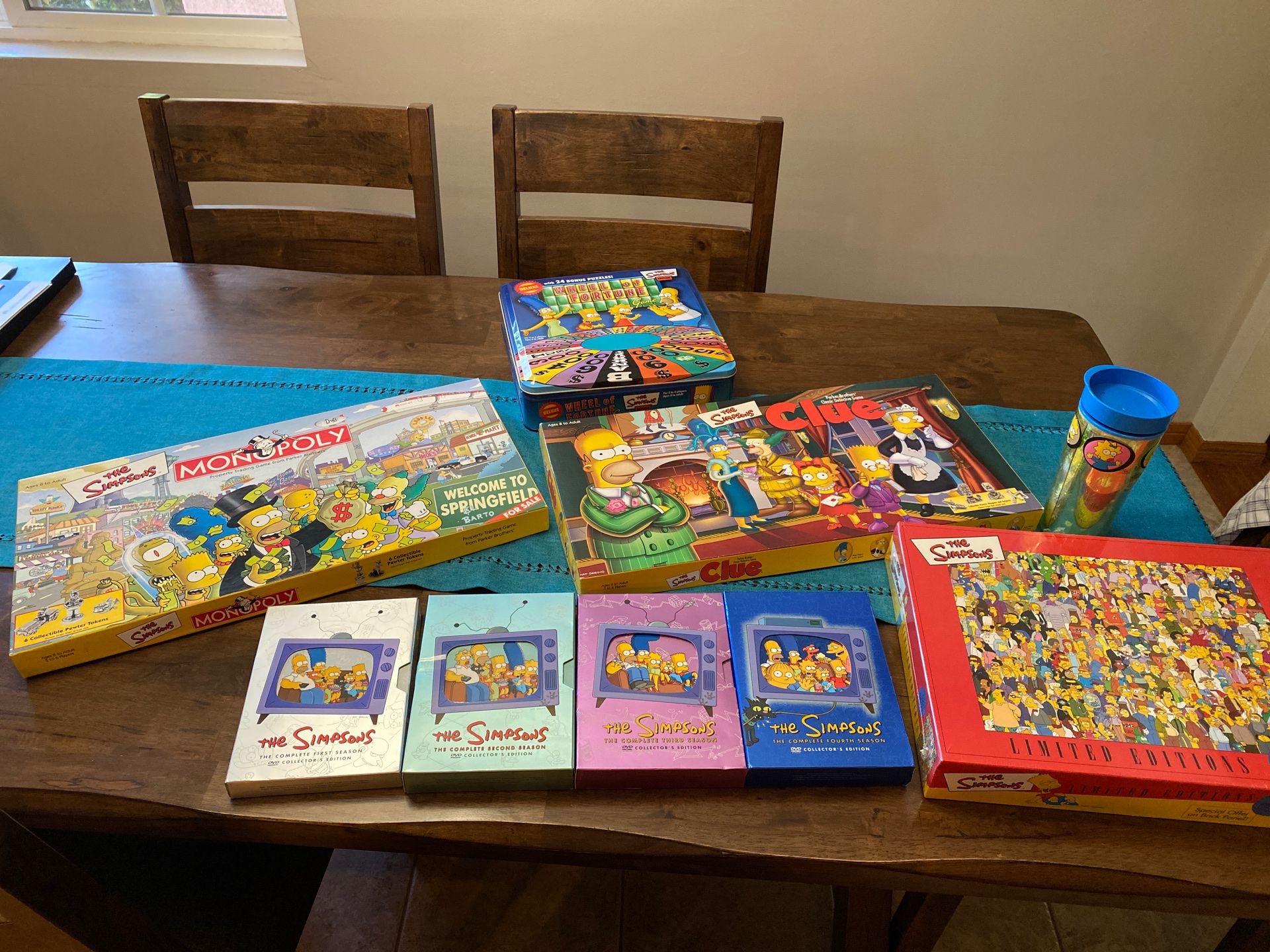 4 Simpson’s games, 4DVDs, Watch, and puzzle collection