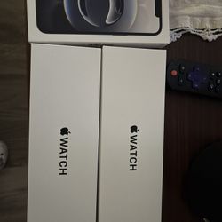 iPhone And Two Apple Watches 