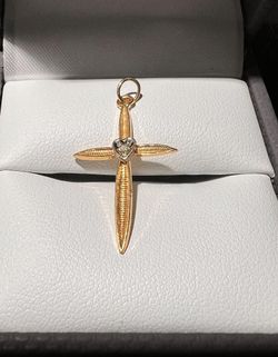 Solid 14k Yellow gold cross pendant with a natural round diamond