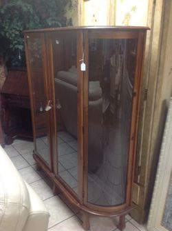 Antique curio display cabinet with curved glass