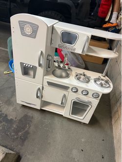 Kids play kitchen with lots of dish hardware