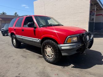 GMC Jimmy Red SUV with Bull Bar